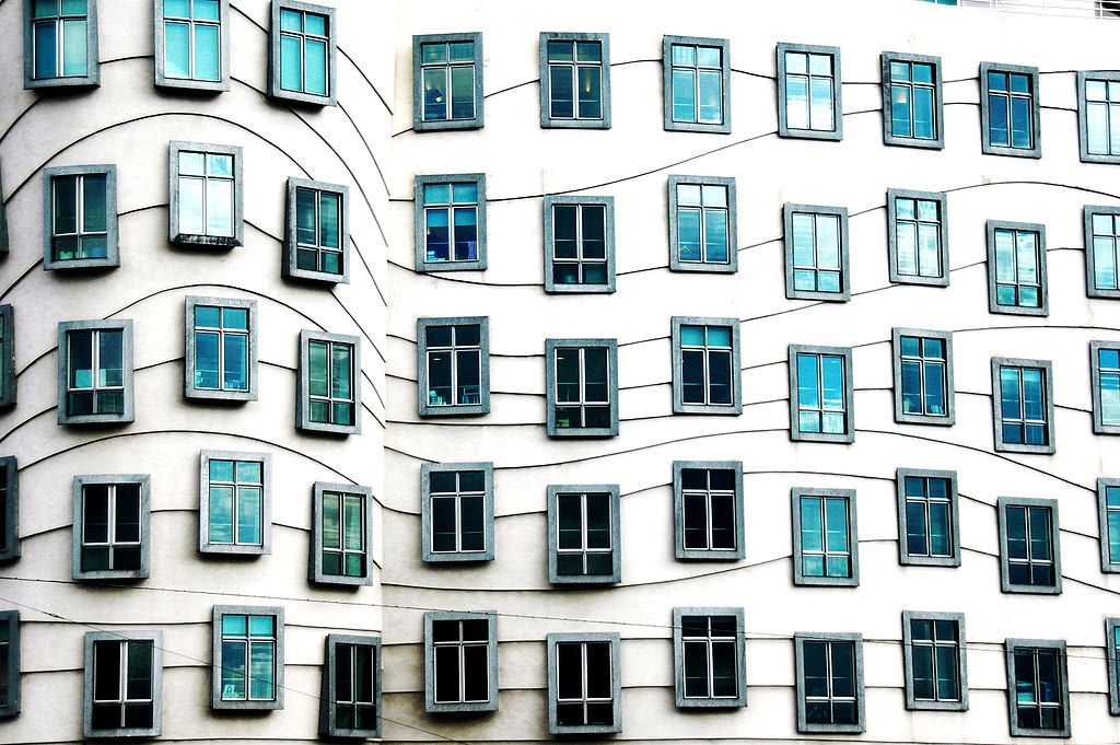 A building with many windows organized in wavy rows